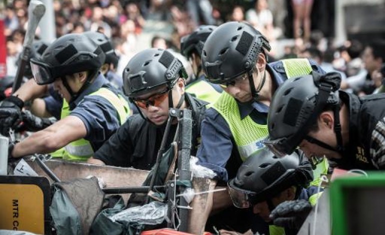 Hong Kong (AFP). Hong Kong: la police enlève des barricades sur un site de manifestations