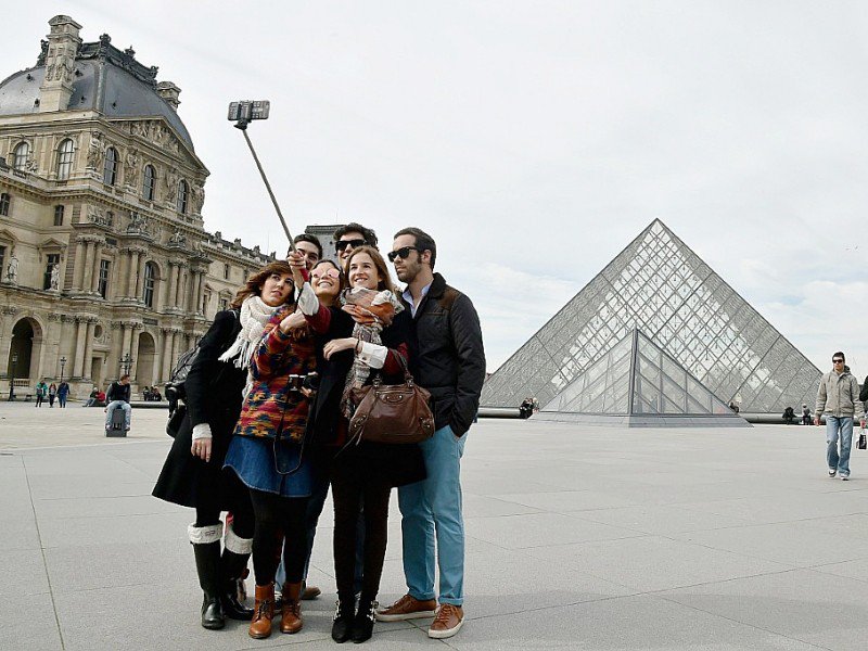 Des touristes devant le Louvre le 7 mars 2015 à Paris - DOMINIQUE FAGET [AFP/Archives]