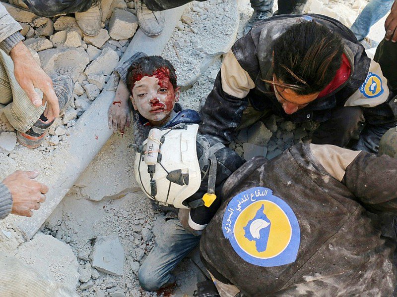 Des Casques blancs de la Défense civile syrienne sauvent un enfant des décombres d'un bâtiment détruit par un bombardement, à Bab al-Nairab, dans le nord d'Alep, le 24 novembre 2016 - AMEER ALHALBI [AFP]
