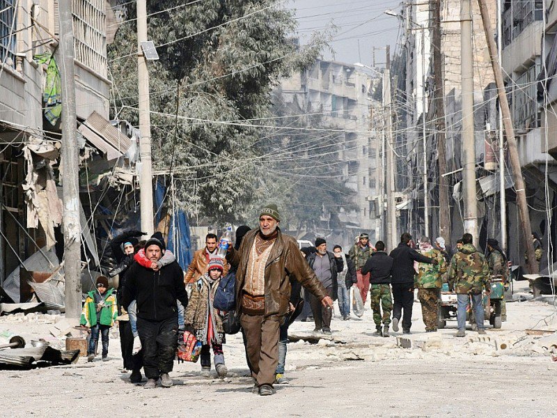 Des civils fuient les violences le 12 décembre 2016 à al-Salihin quartiers d'Alep - GEORGE OURFALIAN [AFP]