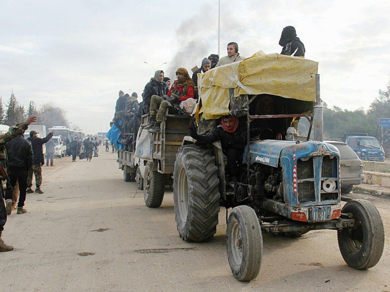 Des évacués des quartiers rebelles d'Alep arrivent en tracteur dans la région de Khan al-Aassal, contrôlée par le gouvernement le 16 décembre 2016 - Omar haj kadour [AFP]