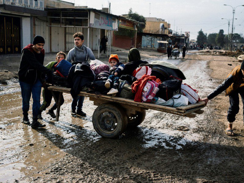 Des Irakiens fuient leurs habitations et sortent leurs effets personnels dans les rues de Mossoul, lors d'une opération militaire, le 8 janvier 2017 - Dimitar DILKOFF [AFP]