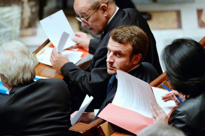Emmanuel Macron (C) devant Jean-Yves Le Drian le 9 décembre 2014 à l'Assemblée nationale à Paris - MIGUEL MEDINA [AFP]