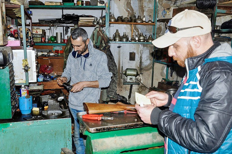 Le Syrien Abboud Jan examine un pistolet dans sa boutique de réparation d'armes, le 18 mars 2017 à Hassaké, dans le nord-ouest du pays - Ayham al-Mohammad [AFP]