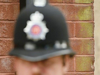 Un officier de police se tient devant la mosquée de Didsbury à Manchester, le 24 mai 2017 - Oli SCARFF [AFP]