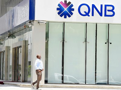 Un homme devant une agence de la Banque nationale du Qatar (QNB) à Riyad, fermée depuis que l'Arabie saoudite a rompu tous liens diplomatiques avec le Qatar, le 5 juin 2017 - FAYEZ NURELDINE [AFP/Archives]