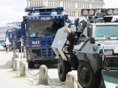 Un véhicule de police blindé et des camions de canon à eau sont stationnés contre des émeutes près de la gare principale de Hambourg, en Allemagne, le 5 juillet 2017 à la veille d'un sommet des dirigeants du G20 - Odd ANDERSEN [AFP]