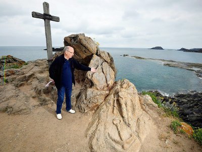 Patrick Cellier, membre de l'association Les amis du travail du prêtre Fouré, montre des rochers sculptés par l'abbé à Saint-Malo le 27 juin 2017 - Damien MEYER [AFP]
