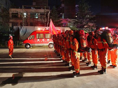 Des pompiers chinois à Longnan s'apprêtent à partir vers des zones sinistrées après un séisme, le 8 août 2017 - STR [AFP]
