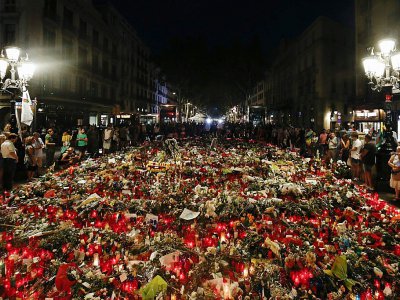 Des gens déposent des fleurs, messages et bougies aux victimes des attentats de Barcelone et Cambrils sur les Ramblas le 22 août 2017 - PAU BARRENA [AFP/Archives]