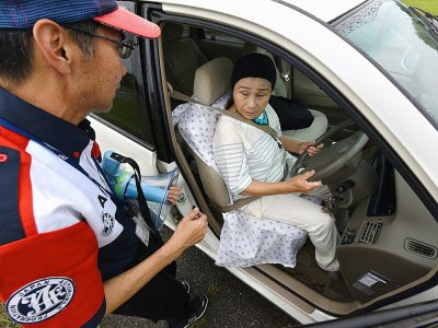 Un instructeur s'adresse à une participante d'un stage de conduite pour seniors organisé par la Japan Automobile Federation (JAF), à Kanuma le 23 juillet 2017 - Kazuhiro NOGI [AFP]