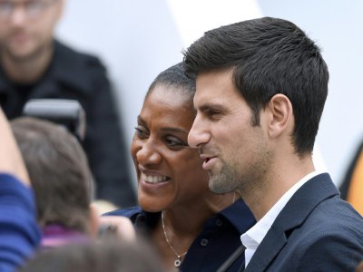 Le tennisman serbe Novak Djokovic (d) et l'ancienne championne olympique française d'athlétisme Marie-José Pérec, le 27 septembre 2017 au défilé Lacoste à Paris - ALAIN JOCARD [AFP/Archives]