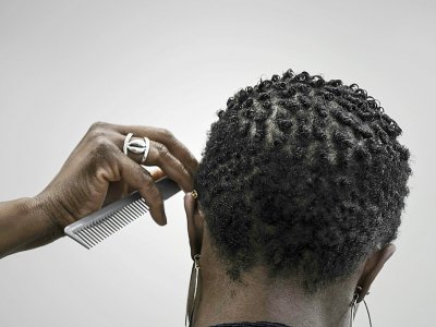 Une cliente d'un salon de coiffure afro spécialisé dans le cheveu naturel frisé et crépu à Bagneux (Hauts-de-Seine), le 19 octobre 2017 - PHILIPPE LOPEZ [AFP]