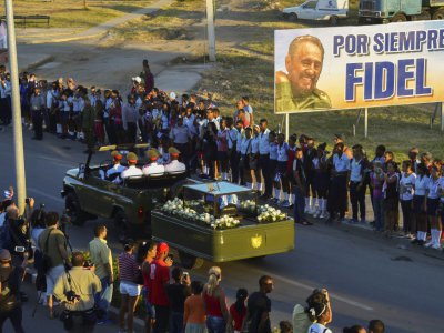 Des Cubains assistent au passage de l'urne funéraire contenant les cendres de Fidel Castro, le 4 décembre 2016 à Santiago de Cuba - RODRIGO ARANGUA [AFP/Archives]