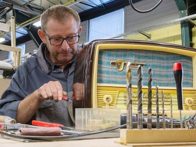 Sylvain Mahe, technicien de l'entreprise "A.bsolument Vintage Radios", modernise l'intérieur d'un poste, à Clermont-Ferrand, le 1er décembre 2017 - Thierry Zoccolan [AFP]