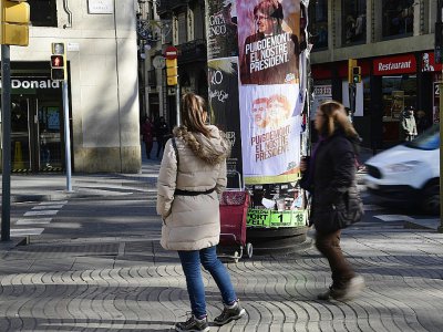 Des passants marchent devant des affiches électorales à Barcelone, le 19 décembre 2017 - JAVIER SORIANO [AFP]