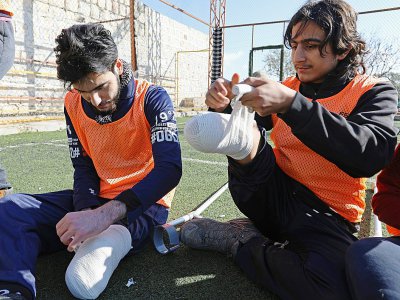 Photo de deux joueurs de l'équipe syrienne de football regroupant des amputés de guerre, prise le 15 janvier 2018 à Idleb - OMAR HAJ KADOUR [AFP]