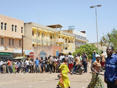 Des passants regardent les dégâts causés au siège de l'état-major de l'armée burkinabè à Ouagadougou le 3 mars 2018, au lendemain d'une double attaque jihadiste - Ahmed OUOBA [AFP]