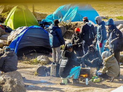 Des migrants près de leurs tentes dans un campement à la périphérie de Calais, le 8 mars 2018 - Philippe HUGUEN [AFP]