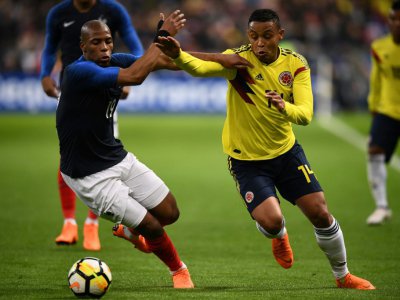 Le défenseur français Djibril Sidibé (g) aux prises avec l'attaquant colombien Luis Muriel lors du match amical, au Stade de France à Saint-Denis, le 23 mars 2018 - FRANCK FIFE [AFP/Archives]