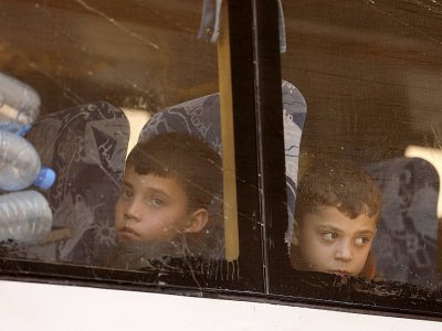 Photos d'enfants syriens syriens évacués de la Ghouta orientale, à leur arrivée à Qalaat al-Madiq, dans le nord de la Syrie, le 26 mars 2018 - OMAR HAJ KADOUR [AFP]