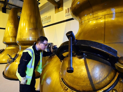 Colin O'Hara surveille le processus de distillation à la distillerie de Auchentoshan, près de Glasgow, le 28 février 2018 - ANDY BUCHANAN [AFP]