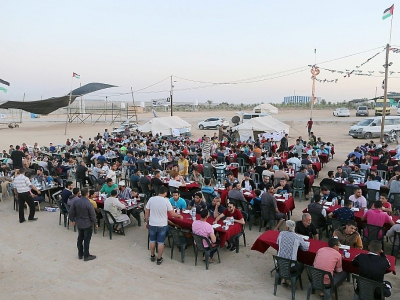 Des Palestiniens de la bande de Gaza rompent le jeûne du ramadan, en mangeant ensemble non loin de la frontière avec Israël, le 17 mai 2018 - MAHMUD HAMS [AFP]