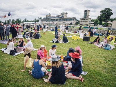 Des spectateurs du Prix de Diane pique-niquent sur la pelouse de l'hippodrome de Chantilly, le 17 juin 2018 - LUCAS BARIOULET [AFP]