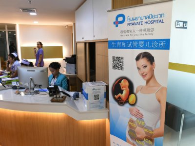 Une affiche d'information en chinois sur la procréation médicalement assistée (PMA), dans le hall d'accueil du Piyavate Hospital, le 17 mai 2018 à Bangkok, en Thaïlande - Lillian SUWANRUMPHA [AFP]