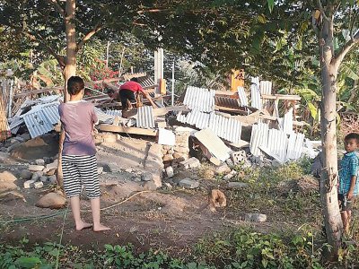 Des Indonésiens parmi les décombres de maisons à Lombok, en Indonésie, après un séisme de magnitude 6.4, le 29 juillet 2018 (photo transmise par l'agence de gestion des catastrophes indonésienne) - Handout [Nusa Tenggara Barat Disaster Mitigation Agency/AFP]