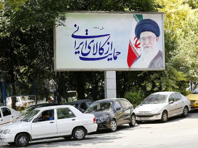 Cars drive by a poster depicting Iran's supreme leader Ayatollah Ali Khamenei in the capital Tehran on July 31, 2018 - ATTA KENARE [AFP]