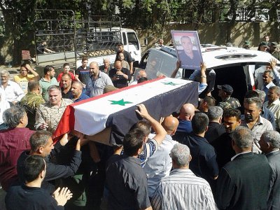 Photo diffusée le 26 juillet 2018 par l'agence de presse syrienne Sana montrant les funérailles de l'une des victimes des attaques commises le 25 juillet 2018 par l'EI dans la ville de Soueida, dans le sud de la Syrie - STR [SANA/AFP]