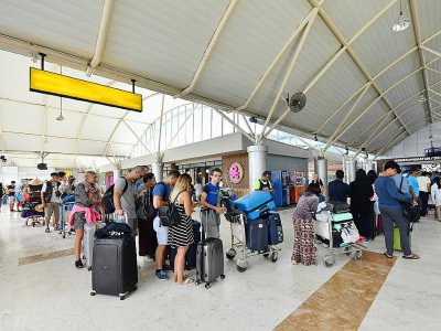 Des touristes à l'aéroport de Lombok après un séisme qui a secoué l'île indonésienne, le 6 août 2018 - Adek BERRY [AFP]