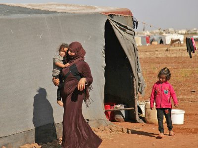 Des Syriens devant une tente dans un camp de déplacés dans la province d'Idleb, le 5 septembre 2018 - Amer ALHAMWE [AFP]