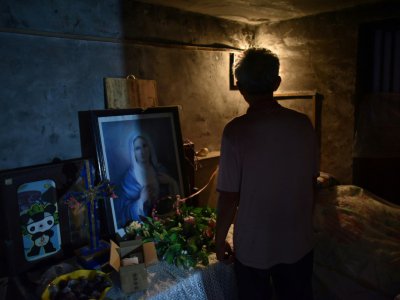 Un homme fait visiter l'église cachée dans une maison à Puyang en Chine, le 13 août 2018 - GREG BAKER [AFP]
