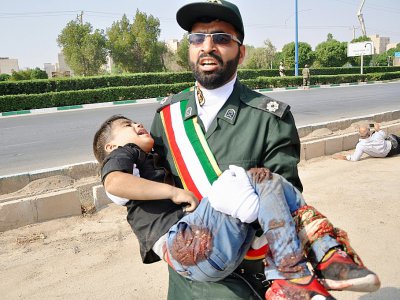 Un Gardien de la révolution porte un enfant blessé lors d'une attaque à Ahvaz, dans le sud-ouest de l'Iran, le 22 septembre 2018 - Shayan HAJI NAJAF [ISNA/AFP]