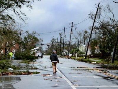 Un homme marche dans les rues de Panama city (Floride) après le passage de l'ouragan Michael, le 10 octobre 2018. - Brendan Smialowski [AFP]
