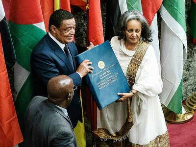 La nouvelle présidente de l'Ethiopie Sahle-Work Zewde (d) reçoit le livre de la Constitution de l'ancien président Mulatu Teshome (g), le 25 octobre 2018 au Parlement à Addis Abeba - EDUARDO SOTERAS [AFP]
