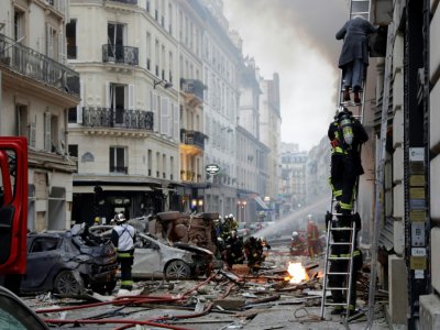 Une femme est évacuée après une explosion dans une boulangerie, le 12 janvier 2019, rue de Trévise dans le 9e arrondissement de Paris - Thomas SAMSON [AFP]