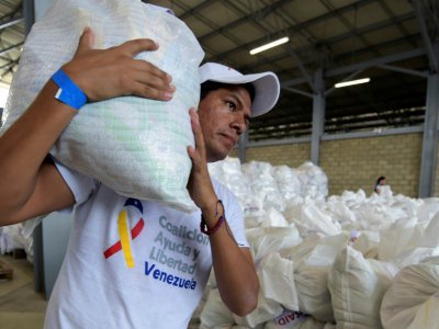 Un volontaire porte un sac contenant de l'aide humanitaire américaine à  Cucuta, en Colombie, à la frontière avec le Venezuela,  le 8 février 2019 - Raul Arboleda [AFP]