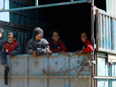 Des enfants à bord d'un camion fuient la dernière poche du groupe Etat islamique (EI) à Baghouz, dans l'est de la Syrie, le 20 février 2019 - Delil SOULEIMAN [AFP]