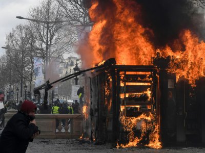 Un des kiosques à journaux des Champs Elysées en feu, pendant la manifestation des "gilets jaunes", à Paris, le 16 mars 2019 - Alain JOCARD [AFP]