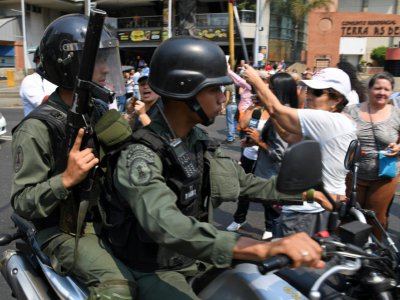 Des policiers vénézuéliens se fraient un chemin lors d'une manifestation en faveur Juan Guaido, le 10 avril 2019 à Caracas - Yuri CORTEZ [AFP]