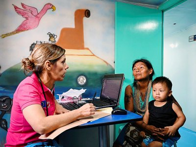 Yenny Cardena, une femme de l'ethnie Wounaan, en consultation avec son enfant à bord du navire-hôpital San Raffaele, le 24 avril 2019 dans le département du Choco, en Colombie - Raul ARBOLEDA [AFP]