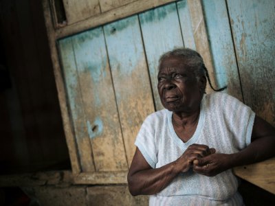 Agida Lucia, 89 ans, devant sa maison dans l'ancienne plantation coloniale Agostinho Neto, à Sao Tomé-et-Principe le 29 mai 2019 - Alexis HUGUET [AFP]