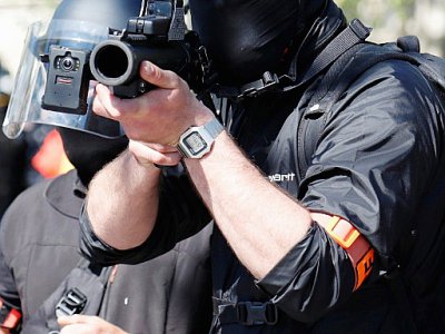 Policier pointant un lanceur de balles de défense (LDB) vers la manifestation de "gilets jaunes", à Paris, le 20 avril 2019 - Zakaria ABDELKAFI [AFP/Archives]