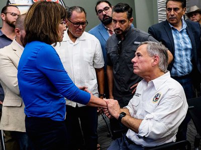 Le gouverneur du Texas Greg Abbott et la députée Evelina Ortega se réconfortent mutuellement à El Paso après la fusillade, le 3 août 2019 - Joel Angel JUAREZ [AFP]