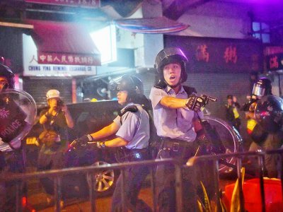 Des policiers pointent leurs armes sur des manifestants, le 25 août 2019 à Hong Kong - Lillian SUWANRUMPHA [AFP]