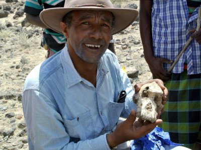 Yohannes Haile-Selassie, du Museum of Natural history de Cleveland, pose avec un fragment du crâne de l'Australopithèque découvert en Ethiopie, le 28 août 2019 - HO [CLEVELAND MUSEUM OF NATURAL HISTORY/AFP]