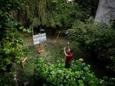Le sculpteur Pascal Catry installe ses oeuvres dans le jardin d'un habitant de Saint-Saturnin le 26 septembre 2019 - JEAN-PHILIPPE KSIAZEK [AFP]